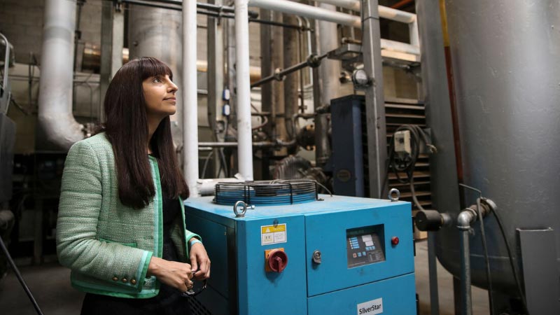 Image of a woman standing in front of machinery