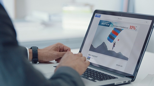 Man using laptop displaying digital advertising. Man using laptop displaying digital advertising.
