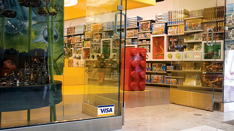 A toy store retailer with the Visa logo displayed at the entrance. A toy store retailer with the Visa logo displayed at the entrance.