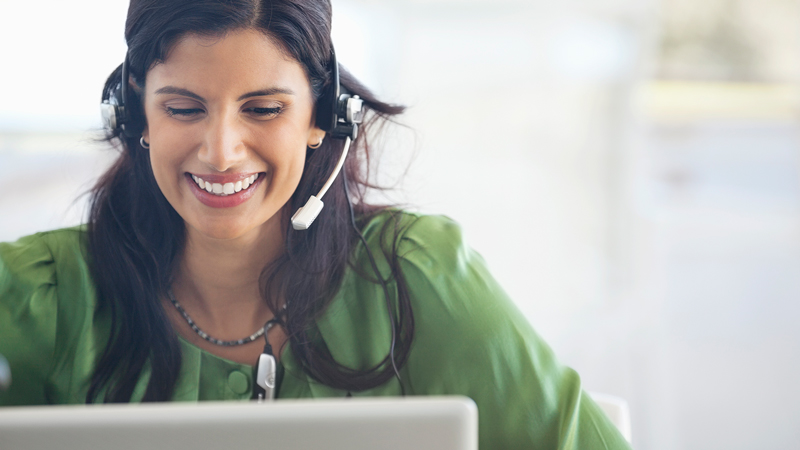 woman_phone_assistance_800x450 Woman wearing a headset using a laptop.