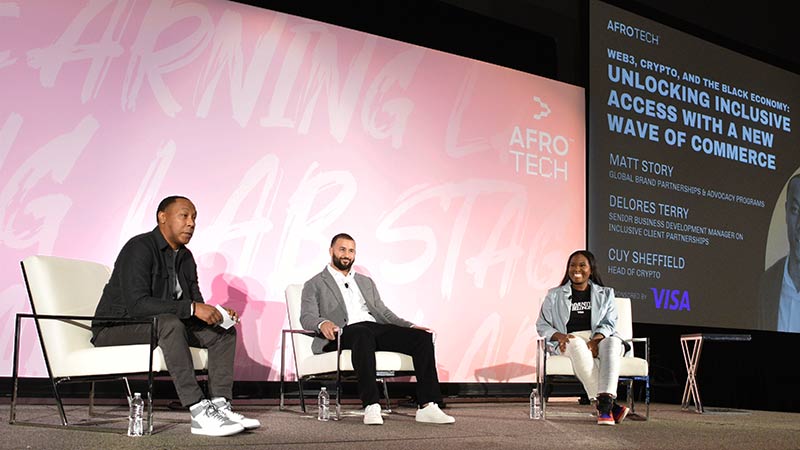 Matt Story, Cuy Sheffield and Delores Terry sit on stage for a panel discussion at AfroTech 2022.