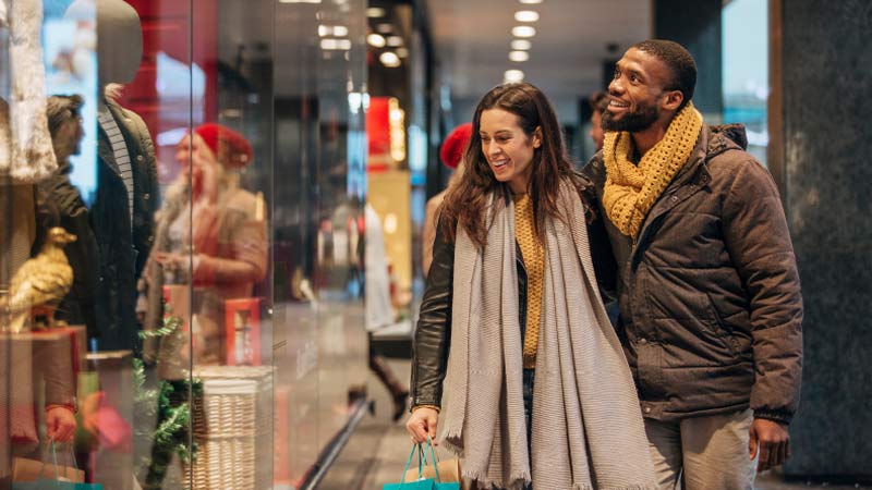 A couple window shopping during the holidays.