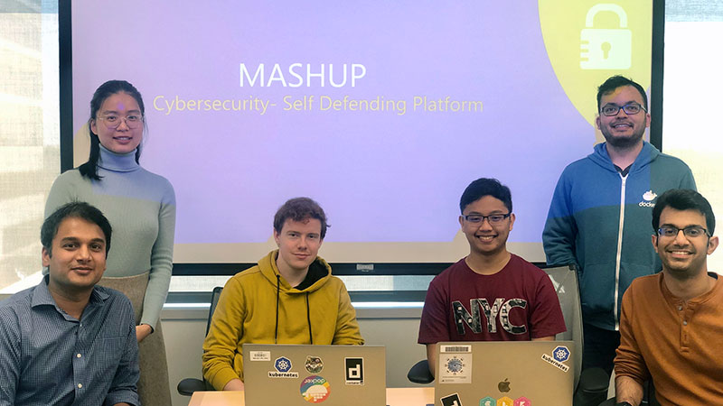 Cybersecurity team smiling in front of the camera