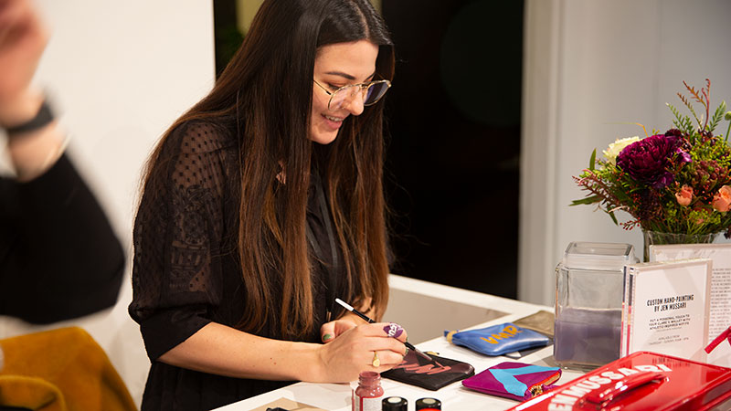 Woman painting on leather