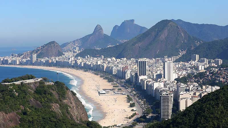 top-trending-summer-travel-destinations-800x450 View of beach, city and mountains.