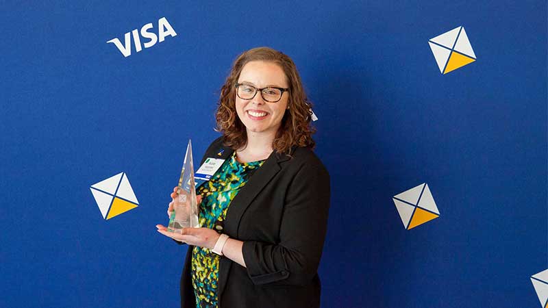 Female award winner holding trophy.