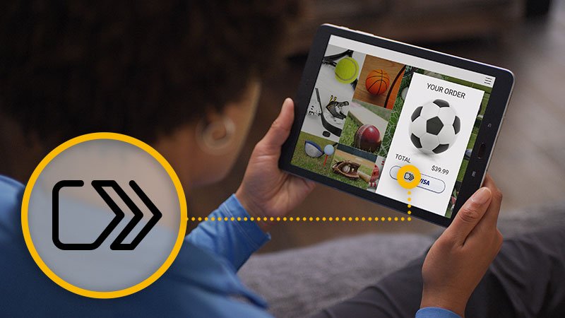 A person is shopping online for soccer gear using a tablet, and the click to pay button which allows for easy shopping is highlighted.