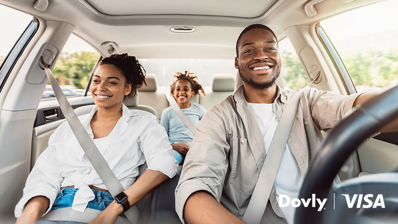 Image of family in car with Dovly and Visa logos and the word NEW in the corner.