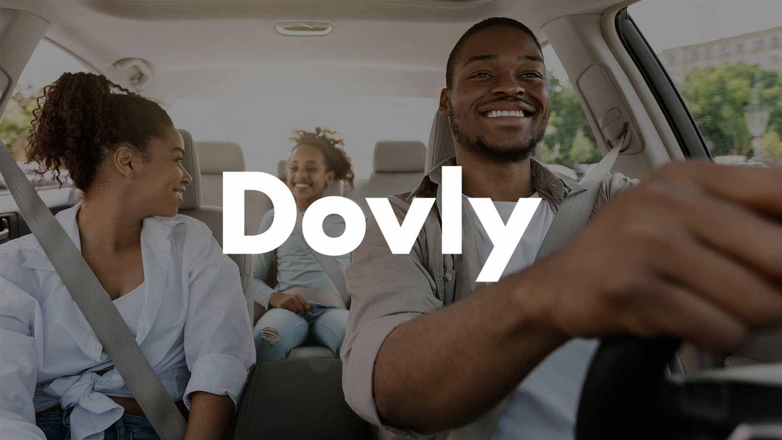 Dovly logo superimposed on image of family driving in car.
