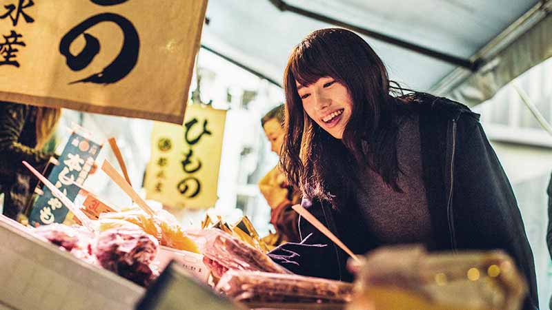 Woman shopping at Tokyo Fish Market in Japan.